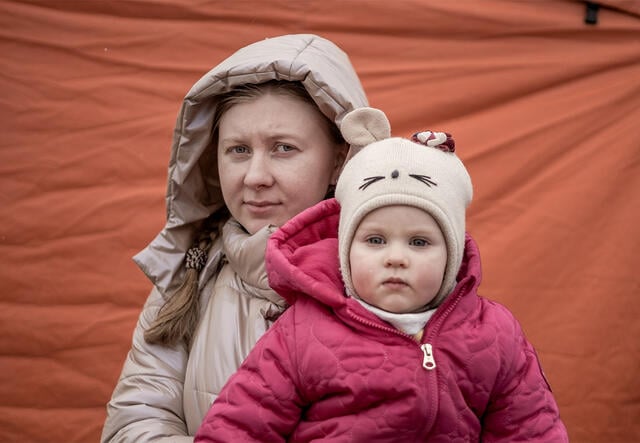 Iryna and her daughter stand near the Medyka border crossing point in Poland after fleeing Ukraine.